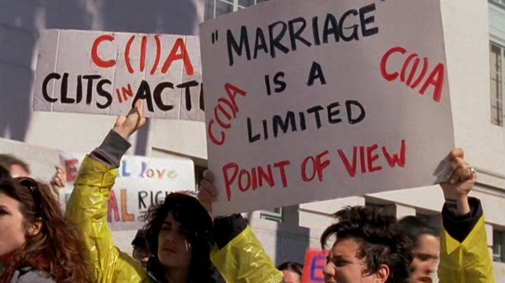 C(I)A at a protest holdiing signs: "Marriage is a Limited Point of View"
