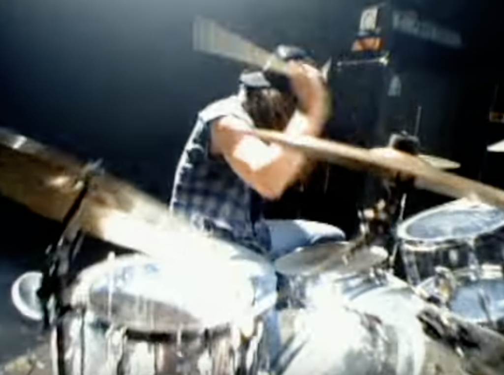 still from "Waiting for a Ride" music video of Dante playing huge drum kit